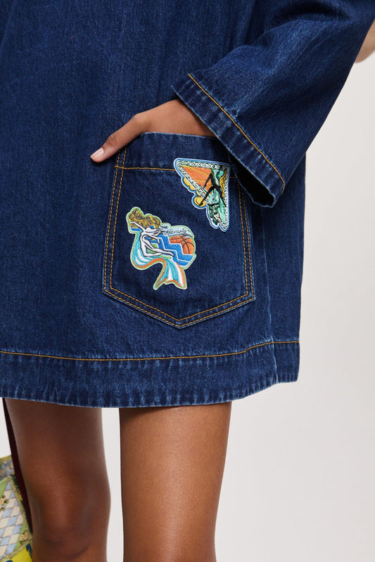 Close up view of Speedy embroidered cotton denim mini dress by Alémais