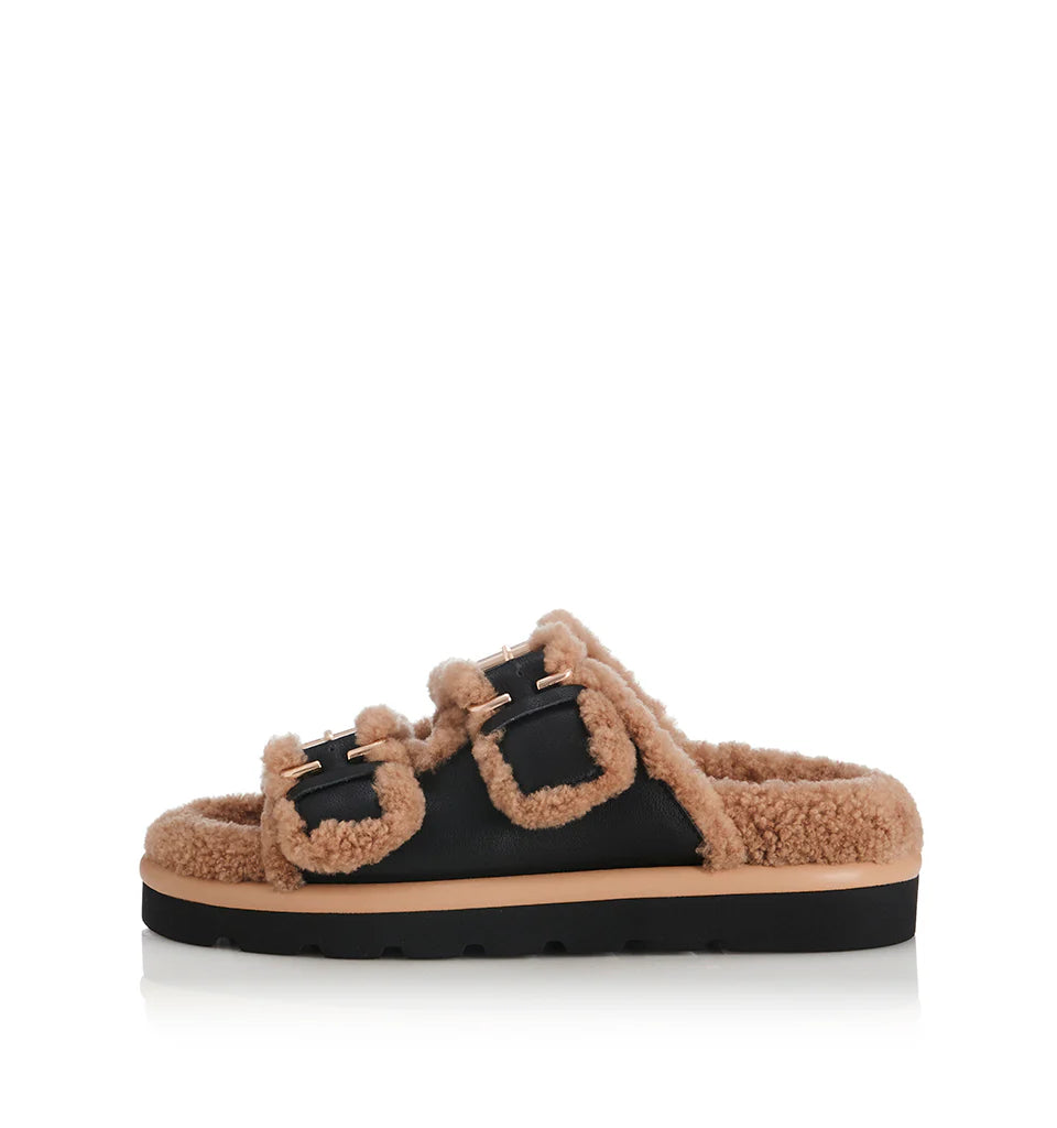 Side view of Alias Mae Saint Slide in black leather with shearling lining
