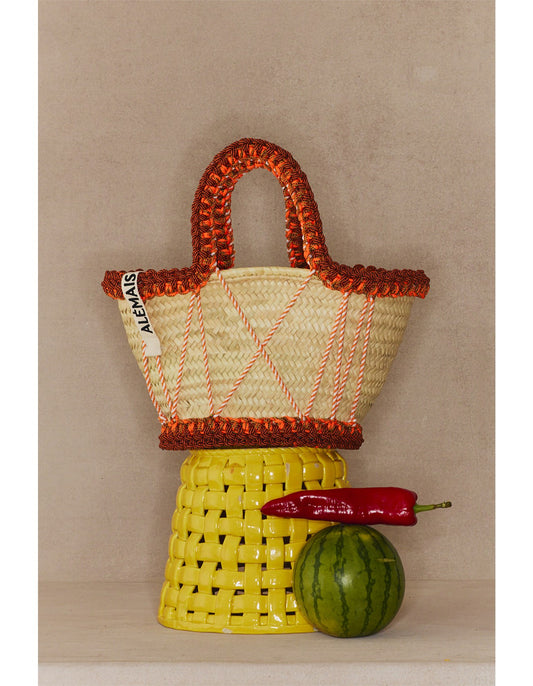 Front view of Rose Medium Basket by Alémais with macramé handle and palm leaf weave